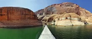 Jetty and red Navajo sandstone cliffs, rock formations rising from Lake Powell, Page, Arizona, USA