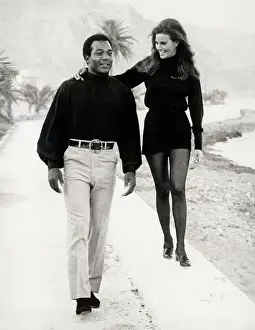Jim Brown Walking with Raquel Welch