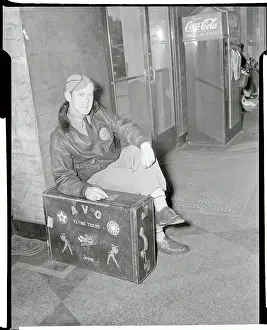 Jimmie Allard Sitting in Uniform With Suitcase