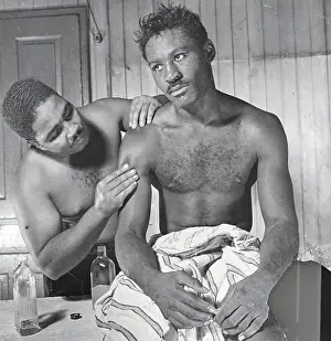 Jimmy Brown Examining Ezzard Charles Arm