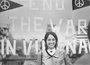 Joan Baez in Front of Sign