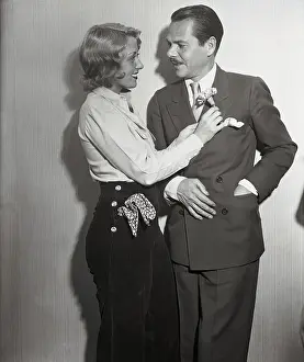 Joan Blondell Placing Flower on Husband's Lapel