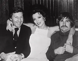 Joan Collins Sitting Between Husband and Director of Film