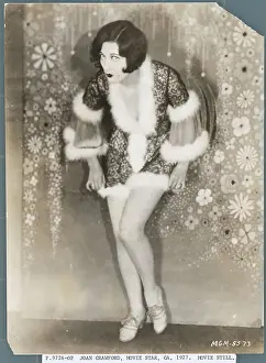 Prints of (Original Caption). Joan Crawford shows a leg as she dances to a girlfriend's ukulele playing in a scene from the MGM production, Our Modern Maidens A Glamorous Life Captured: Joan Crawford Dancing