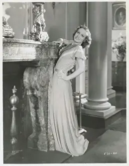 Prints of (Original Caption). Joan Crawford, as she appears in her latest MGM starring picture, Dance, Fools, Dance A Glamorous Life Captured: Joan Crawford Leaning on Mantel