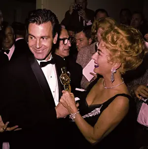 Prints of Actor Maximilian Schell and actress Joan Crawford holding an Oscar statuette. In 1962 Maximilian Schell won Oscar for best actor in Judgement at Nuremberg A Glamorous Life Captured: Joan Crawford and Maximilian Schell Holding Oscar