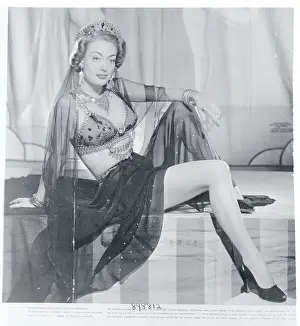Prints of (Original Caption). Lace and Silk for Afternoon. Skirt of black silk, combined with blouse of lace forms this lovely afternoon dress worn by Joan Crawford, MGM star A Glamorous Life Captured: Joan Crawford Posing in Silk Dress