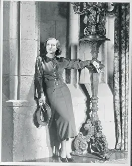 Prints of (Original Caption). The Movie Manner. Blue Broadcloth, with fringes from shoulders to wrists across the sleeve top, makes this smart sports dress for Joan Crawford, MGM star A Glamorous Life Captured: Joan Crawford Posing in Sports Dress