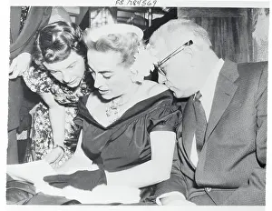 Joan Crawford Signing an Autograph Book