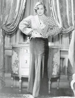 Prints of (Original Caption). Attired for Evening A Glamorous Life Captured: Joan Crawford Wearing Navy Blue Evening Ensemble