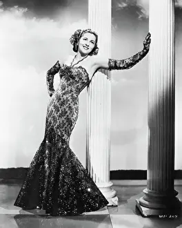 Joan Fontaine Stands Leaning on Column