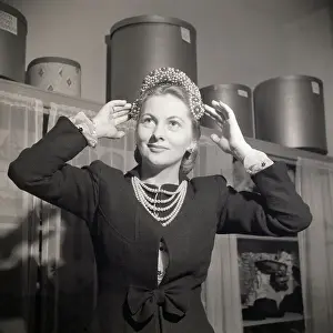 Full Face Prints: Joan Fontaine Tries On Beaded Hat