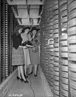 Joan Leslie and Family Looking at Films in a Film Vault