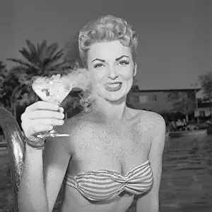Joan Sanders Holding a Cocktail