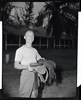 Jockey Eddie Arcaro Holding Saddle
