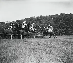 Jockeys Riding Horses over Obstacles