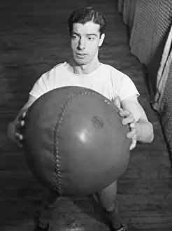 Joe DiMaggio Holding Medicine Ball