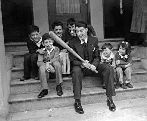 Prints of (Original Caption) The Yankee Clipper - A Legacy in Timeless Images: Joe DiMaggio Sitting with Children and Holding Baseball Bat