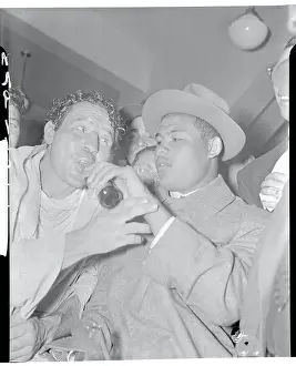 Joe Louis Assisting Max Baer with Water Bottle