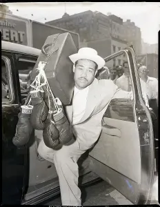 Entering Prints: Joe Louis in Cab with Suitcase and Gloves