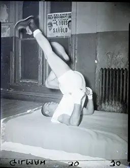 Gymnasium Prints: Joe Louis Doing Leg Exercises