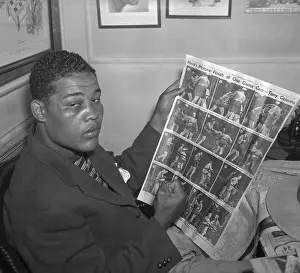 Joe Louis Observing Photographs