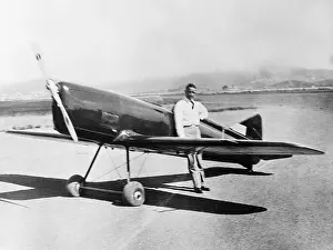 John A Prints: John A. MacReady Posing with Plane