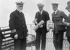 John Alcock Holding Model Airplane with Officers Nearby