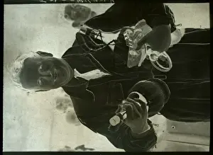 John Cunningham Carrying Bottles of Wine