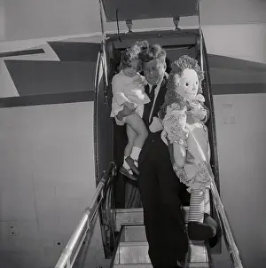 John F Kennedy Carrying His Daughter Caroline and Giant Doll