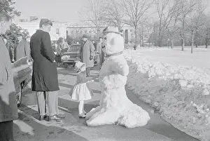 John F Kennedy and Daughter Caroline Admiring Snowman