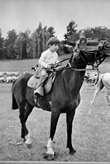 John F. Kennedy Jr. Riding a Horse