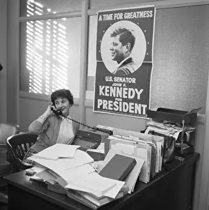 John F. Kennedy Looking at campaign Poster