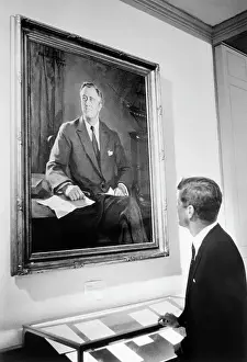 John F. Kennedy Observing a Large Portrait of Franklin D. Roosevelt