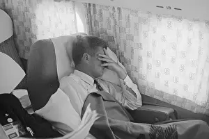 Passenger Airplane Prints: John F. Kennedy Resting in Passenger Cabin of Airplane