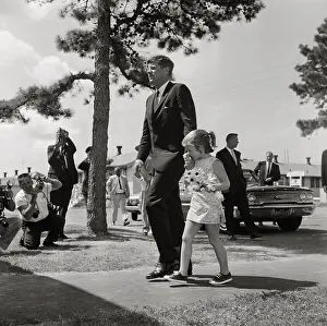John F. Kennedy and Young Daughter Caroline Walking by Reporters