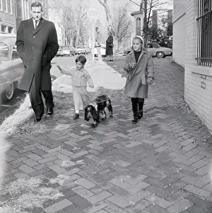 John Fitzgerald Kennedy Jr. and Cousin Walking a Dog