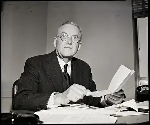 John Foster Dulles Seated At Desk