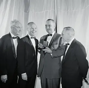 John Glenn and Others Admiring Medal