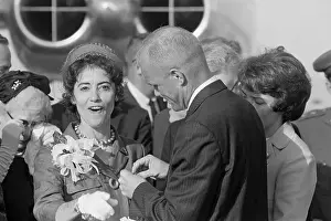 John Glenn Pins Button On Excited Wife