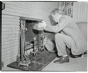 John Huston Throwing Log onto Fire