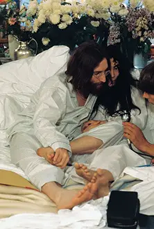 John Lennon and Yoko Ono in Bed Speaking into Microphone