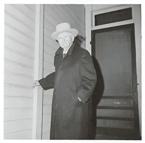 John Nance Garner Pausing in Overcoat and Hat