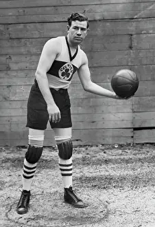 Prints of American basketball player John Barry (also known as Pete Barry), Boston Celtics forward, poses with a basketball in his left hand, Boston, Massachusetts, circa 1925 Courtside Vibes: Stunning Basketball Prints: John Pete Barry, Boston Celtics Forward