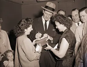 Autographing Prints: John Wayne Signing Autographs for Fans