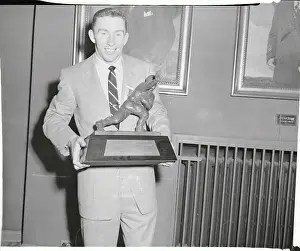Johnny Lattner Holding Heisman Trophy