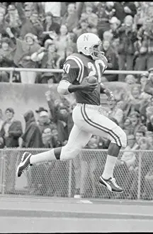 Football Team Prints: Johnny Rodgers Running In Air with Ball