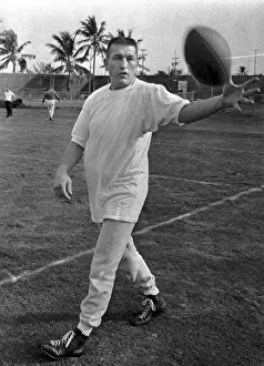 Johnny Unitas Reaching for Ball During Practice