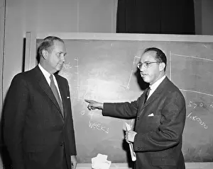 Salk Prints: Jonas Salk and Leonard Scheel Talking at Blackboard