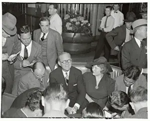 Joseph P. Kennedy Sitting Surrounded by Reporters
